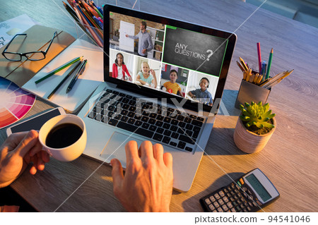 Hands of man using laptop for video call, with smiling diverse elementary school pupils on screen Hands of man using laptop for video call, with smiling diverse elementary school pupils on screen 94541046