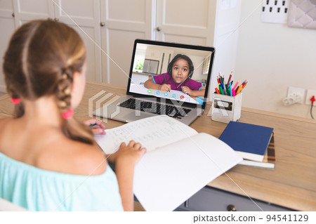 Caucasian girl using laptop for video call, with elementary school pupil on screen Caucasian girl using laptop for video call, with elementary school pupil on screen 94541129