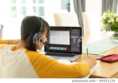 Asian girl using laptop for video call, with class on screen Asian girl using laptop for video call, with class on screen 94541134
