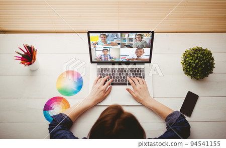 Caucasian woman using laptop for video call, with smiling diverse high school pupils on screen Caucasian woman using laptop for video call, with smiling diverse high school pupils on screen 94541155