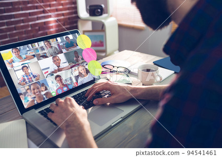 Caucasian man using laptop for video call, with diverse elementary school pupils on screen Caucasian man using laptop for video call, with diverse elementary school pupils on screen 94541461