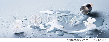 Pipette, cosmetic product and White flowers in glass slide on blue banner, selective focus Pipette, cosmetic product and White flowers in glass slide on blue banner, selective focus 94542383