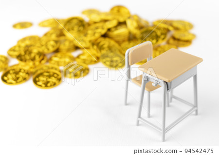 Toy gold coins and a study desk. image of financial education Toy gold coins and a study desk. image of financial education 94542475
