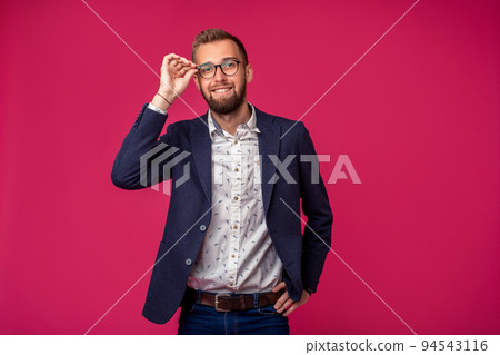 Portrait view of an attractive happy businessman with glasses on a pink background Portrait view of an attractive happy businessman with glasses on a pink background 94543116