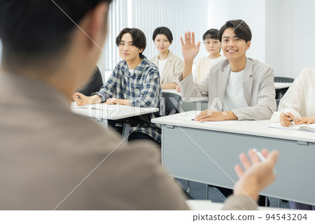 Business seminar A young man raising his hand and asking a question Business seminar A young man raising his hand and asking a question 94543204