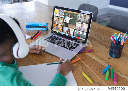 African american boy using laptop for video call, with diverse elementary school pupils on screen African american boy using laptop for video call, with diverse elementary school pupils on screen 94544200