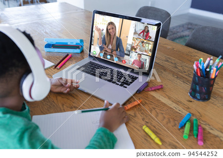 African american boy using laptop for video call, with diverse high school pupils on screen African american boy using laptop for video call, with diverse high school pupils on screen 94544252