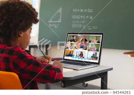 African american boy using laptop for video call, with diverse elementary school pupils on screen African american boy using laptop for video call, with diverse elementary school pupils on screen 94544261