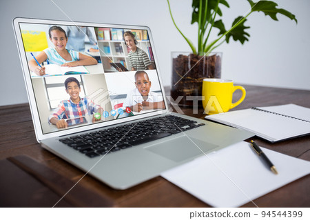 Smiling diverse elementary school pupils during class on laptop screen Smiling diverse elementary school pupils during class on laptop screen 94544399