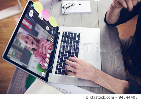 Hands of man using laptop for video call, with elementary school pupil on screen Hands of man using laptop for video call, with elementary school pupil on screen 94544403