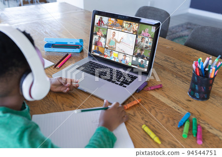 African american boy using laptop for video call, with diverse elementary school pupils on screen African american boy using laptop for video call, with diverse elementary school pupils on screen 94544751