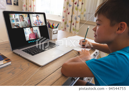 Caucasian boy using laptop for video call, with smiling diverse high school pupils on screen Caucasian boy using laptop for video call, with smiling diverse high school pupils on screen 94544755