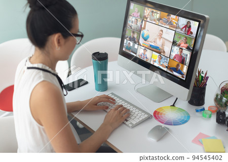 Caucasian girl using computer for video call, with diverse elementary school pupils on screen Caucasian girl using computer for video call, with diverse elementary school pupils on screen 94545402