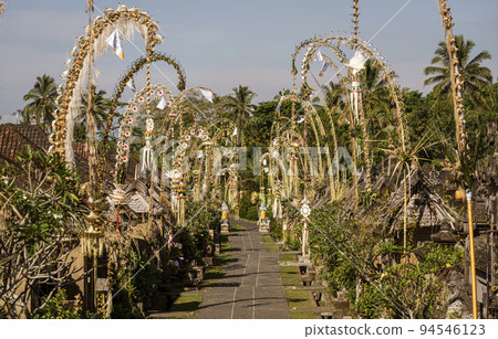 Indonesia - Street is lined with Penjors on Galungan Day in Bali Indonesia - Street is lined with Penjors on Galungan Day in Bali 94546123