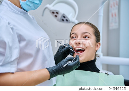 Young teenage female at dental checkup in clinic. Young teenage female at dental checkup in clinic. 94546225