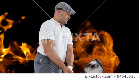 Composition of male golf player over flames on black background Composition of male golf player over flames on black background 94546583