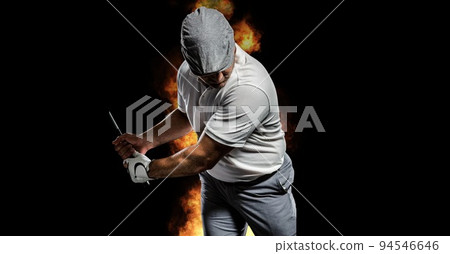 Composition of male golf player over flames on black background Composition of male golf player over flames on black background 94546646