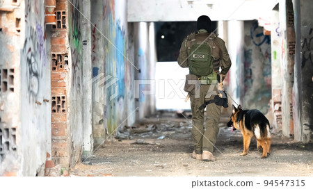 Modern Warfare Soldiers with military working dog in action on the battlefield. Modern Warfare Soldiers with military working dog in action on the battlefield. 94547315