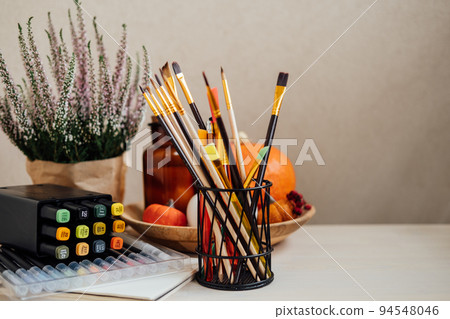 Drawing painting background. Colorful paints, brushes, stationery, supplies for drawing and craft. Creative education setting, artist desk top view, copy space 94548046