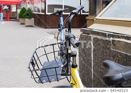 Handlebar and bicycle basket on the road Handlebar and bicycle basket on the road 94548323