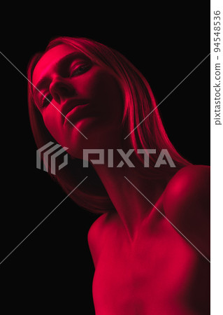 Desire and love. Dark red night. Young sensual woman in neon light on dark background. Cyberpunk style, beauty, halloween concept. 94548536