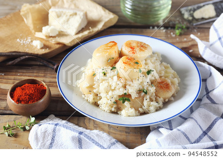 Italian cuisine. Plate of scallop risotto, olive oil and parmesan cheese 94548552