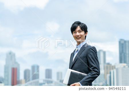 A young businessman doing business outside A young businessman doing business outside 94549211