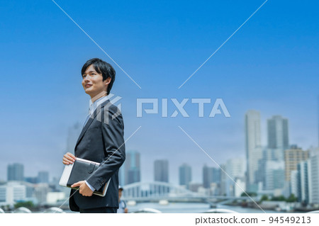 A young businessman doing business outside 94549213