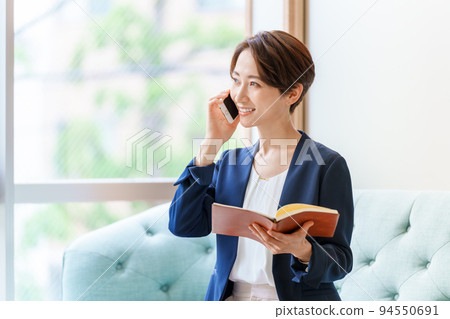 Career woman making a phone call Career woman making a phone call 94550691