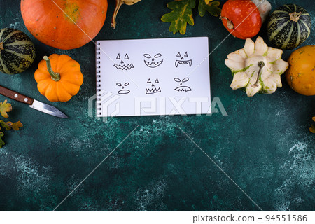 Notebook with scary face for making Halloween jack-o-lantern 94551586