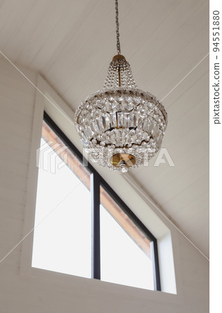 large beautiful vintage crystal chandelier in a light room large beautiful vintage crystal chandelier in a light room 94551880