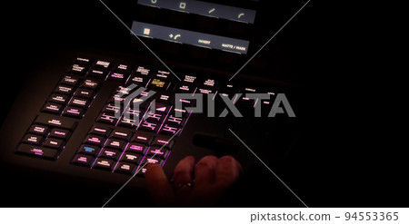 Edit video production control panel in studio. Editor editing and grade film in movie post room. Telecine control machine and man hand editing or adjusting color on digital video in post production. 94553365