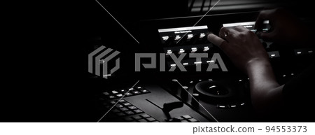 Edit video production control panel in studio. Editor editing and grade film in movie post room. Telecine control machine and man hand editing or adjusting color on digital video in post production. 94553373
