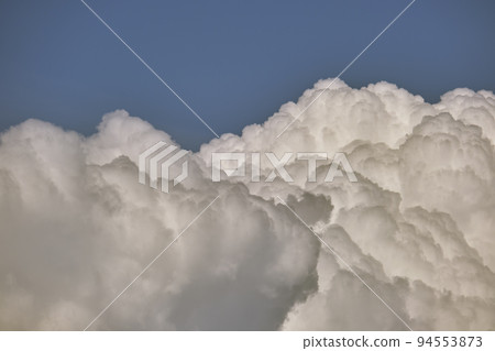 White puffy cumulus clouds on summer blue sky 94553873