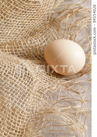 Fresh organic chicken eggs in carton pack or egg paper container on a sacking. Zero waste packaging concept Fresh organic chicken eggs in carton pack or egg paper container on a sacking. Zero waste packaging concept 94554026