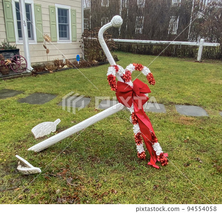 White ships anchor on a front lawn decorated for the Christmas Holiday White ships anchor on a front lawn decorated for the Christmas Holiday 94554058