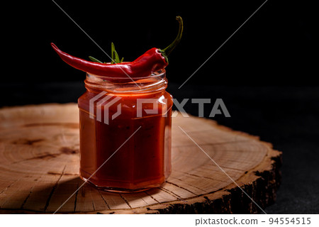 Glass jar with homemade classic spicy tomato pasta or pizza sauce with spices and herbs 94554515