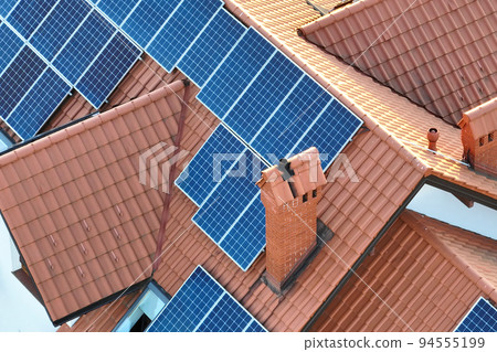 Aerial view building roof with rows of blue solar photovoltaic panels for producing clean ecological electric energy. Renewable electricity with zero emission concept 94555199