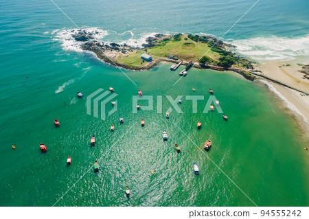 Coastline with rocky island, beach and ocean with waves. Aerial view of Ponta das Campanhas in Floripa 94555242