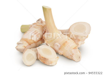 Fresh galangal root with slices isolated on white background with full depth of field. Fresh galangal root with slices isolated on white background with full depth of field. 94555322