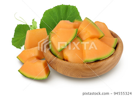 Cantaloupe melon pieces in wooden bowl isolated on white background with full depth of field. 94555324