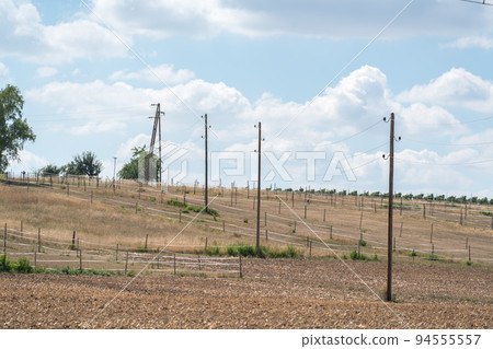 Older wooden overhead power transmission line across the landscape Older wooden overhead power transmission line across the landscape 94555557