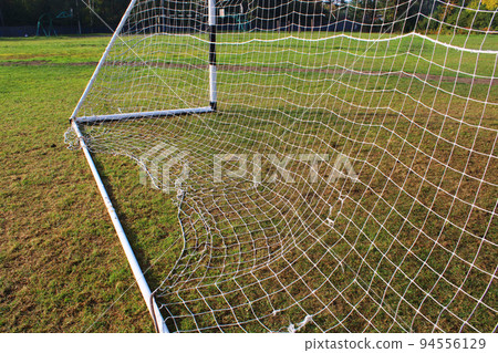 Old football goal against the background of the football field and autumn forest Old football goal against the background of the football field and autumn forest 94556129