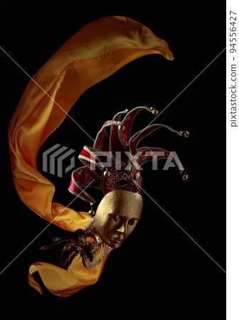 Old carnival masks with flutters yellow cloth. Old carnival masks with flutters yellow cloth. 94556427