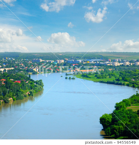 Aerial view of Dniester River between Moldova, Soroca city on right. 94556549