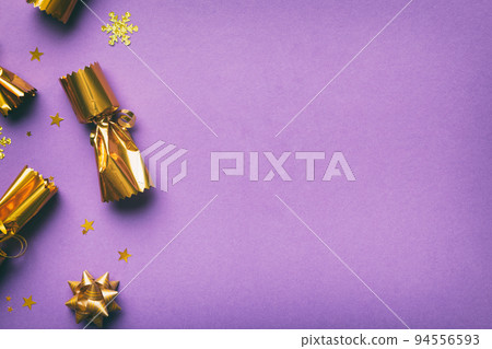 Christmas crackers with shiny confetti on color background, top view, copy space Christmas crackers with shiny confetti on color background, top view, copy space 94556593
