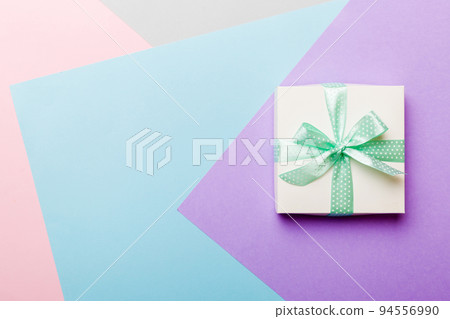 holiday handmade white present tied green ribbon bow top view with copy space. Flat lay holiday background. Birthday or christmas present. Christmas gift box concept with copy space 94556990