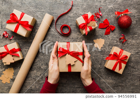 Woman hands holding gift box, preparing surprise for holiday, top view, Christmas and New Year concept 94556991