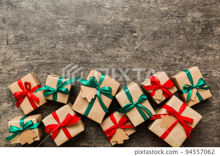 wrapped christmas or other holiday handmade present in paper with colored ribbon. Present box, decoration of gift on colourfull table, top view with copy space wrapped christmas or other holiday handmade present in paper with colored ribbon. Present box, decoration of gift on colourfull table, top view with copy space 94557062
