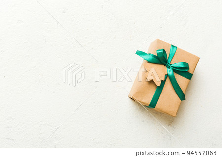 wrapped christmas or other holiday handmade present in paper with colored ribbon. Present box, decoration of gift on colourfull table, top view with copy space wrapped christmas or other holiday handmade present in paper with colored ribbon. Present box, decoration of gift on colourfull table, top view with copy space 94557063
